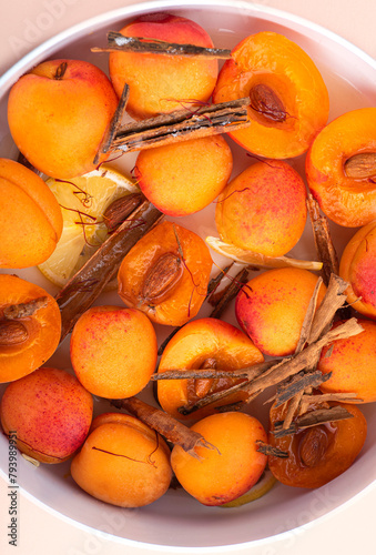 Fresh peaches for rosted and make an easy summer dessert with saffron, cinnamon, almonds, lemon and sugar. Light summer desserts based on fruits. Healthy eating in summer photo