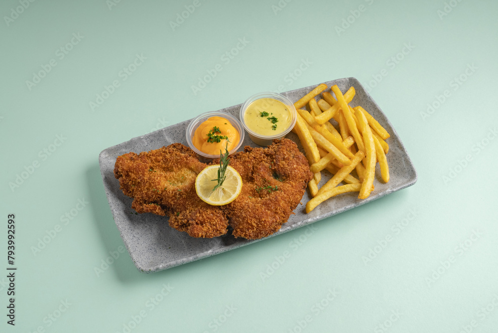 Crispy beef tenderloin flattened served with French fries, mustard and cheese sauce