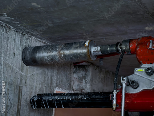 Huge cement drill machine in action high in the ceiling