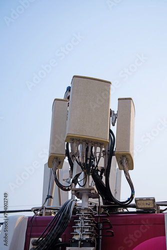 Small Cell 4G, 5G System. Macro Base Station or Base Transceiver Station. Wireless Communication Antenna Transmitter. Development of communication system in urban area on car roof.