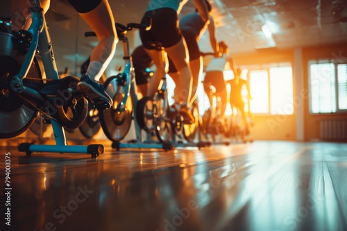 Group riding exercise bikes in gym for fitness recreation photo