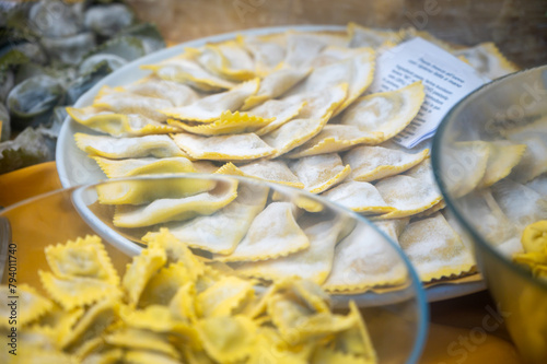 Italian food, fresh homemade stuffed pasta tortelli or ravioli dumplings ready to cook, Milan, Lombardy, Italy photo