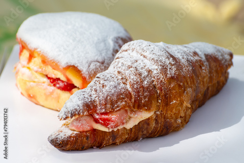 Dutch cuisine, fresh baked strawberry cake and croissant with cream and fresh fruits