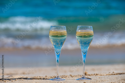 Pouring a glass of champagne on vacation, south of Fuerteventura, Canary islands, blue ocean, mountains photo