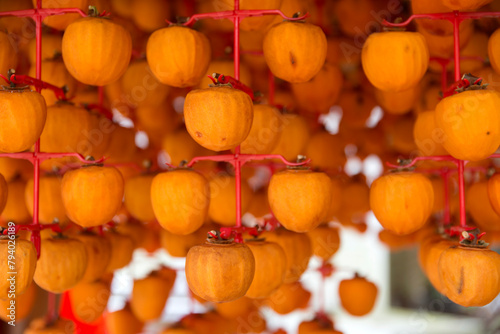 View of drying peeled persimmons in autumn photo