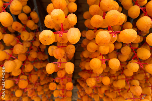 View of drying peeled persimmons in autumn photo