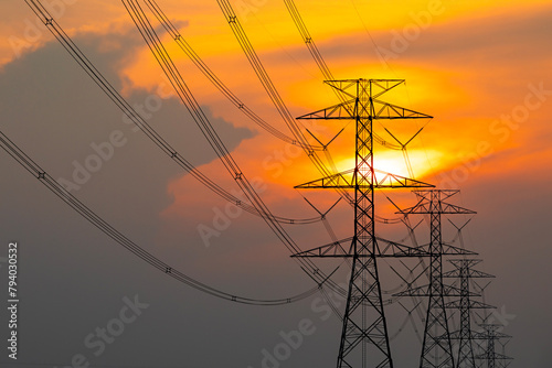 Silhouette of electricity transmission pylon. high-voltage power lines. high voltage post during sunset time.
