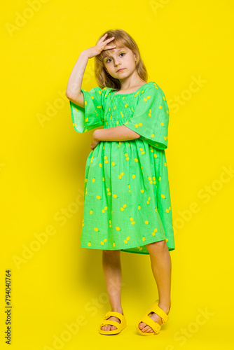 Face palm. Shame on you. Upset young blonde child girl kid making face palm gesture, feeling bored, disappointed in result, bad news. Little preteen children isolated on yellow background. Vertical