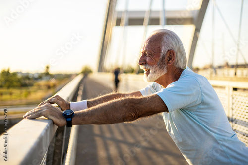 Elderly male training pushups getting ready for healthy workout. Healthy retirement lifestyle. Sports fitness and physical exercises for the elderly. photo