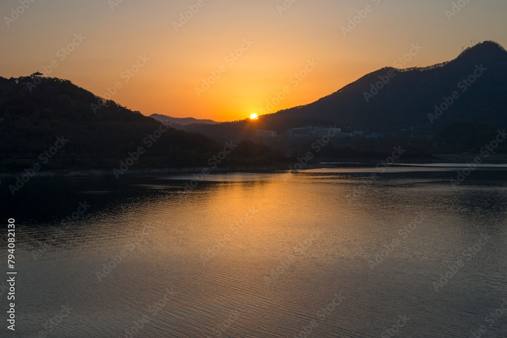 View of the sunset over the mountain at the lakeside View of the sunset over the mountain at the lakeside