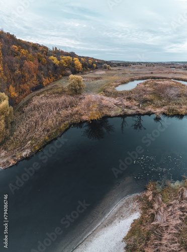 Aerial river valley scenic vertical panorama in autumn with grey cloudy sky in Ukraine countryside