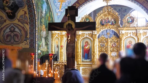 People worshiping Jesus on the cross in an orthodox christian church photo