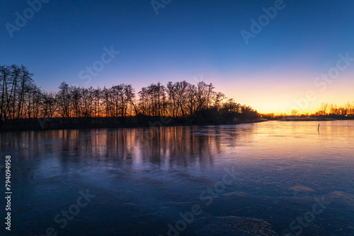 Evening landscape at sunset by the pond.