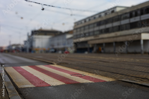 Colorful pedestrian crossing in front of the main train station in the city. The background is blurred by a photographic technique