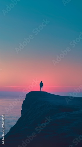 Man standing alone on a cliff during sunset
