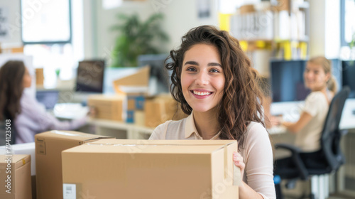 Young smiling woman groups the order. Issuing orders from the warehouse. Woman holding a box on the background of the warehouse. Order picker. Delivery, shipping department