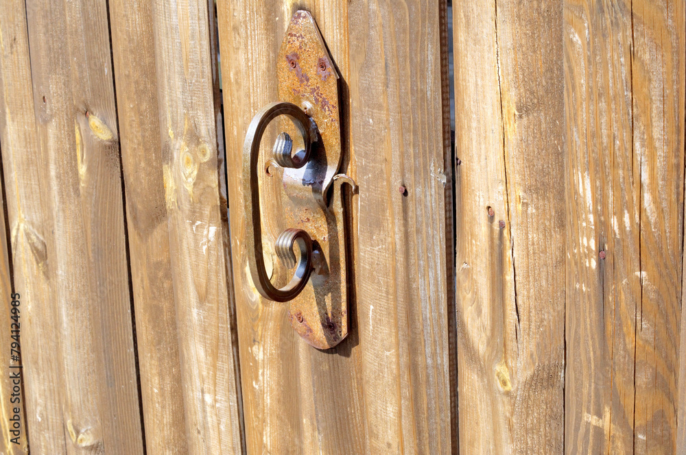 Forged handle on a wooden door
