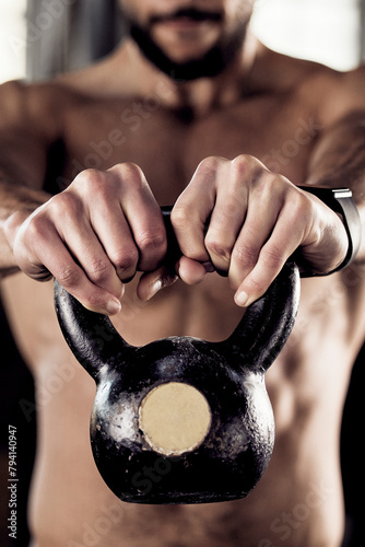 Hands, kettlebell and man in gym, exercise or strength training with equipment, health or fitness. Closeup, person or bodybuilder in wellness center, workout or strong with challenge or weightlifting