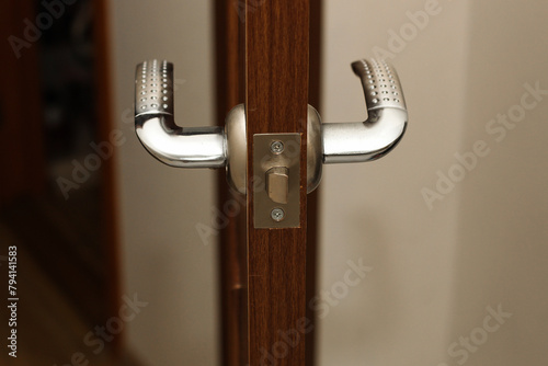 A door lock with a handle on the door in the apartment