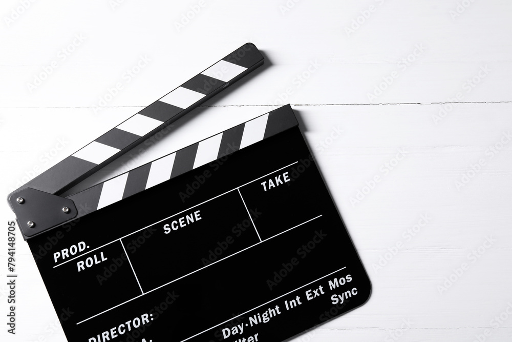 Clapperboard on white wooden table, top view. Space for text