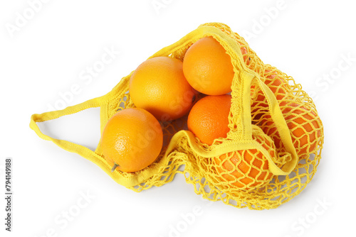 Fresh oranges in yellow string bag isolated on white, top view