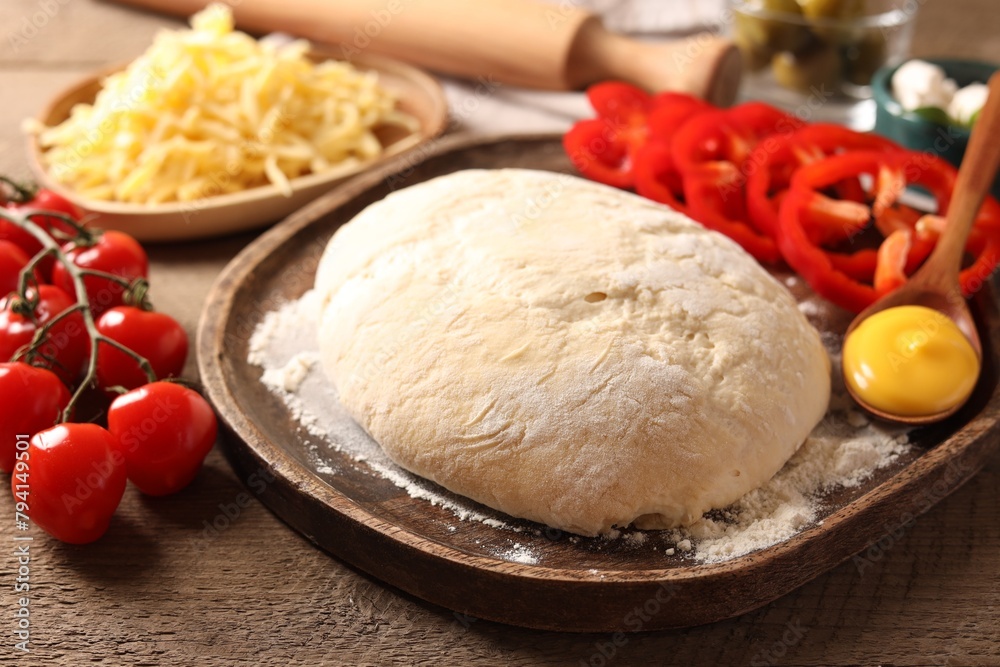 Pizza dough and products on wooden table, closeup Pizza dough and products on wooden table, closeup