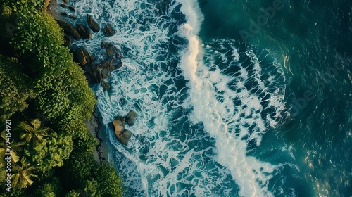 aerial view of dynamic ocean waves crashing against the tropical beach shoreline capturing the powerful and serene nature of the sea