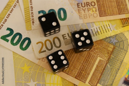 Investment with risks concept. Three dice on new 200 euro banknotes.