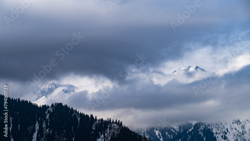 snowy mountain peaks in the clouds. cloud cover in the mountains