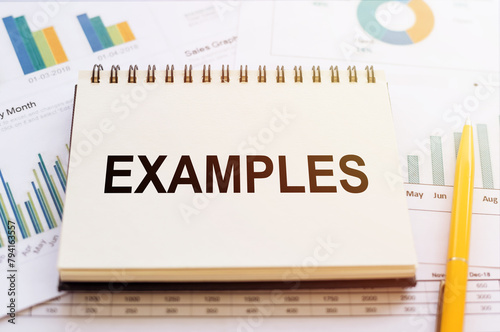 A notebook with the word examples written on its cover, set against a business background.