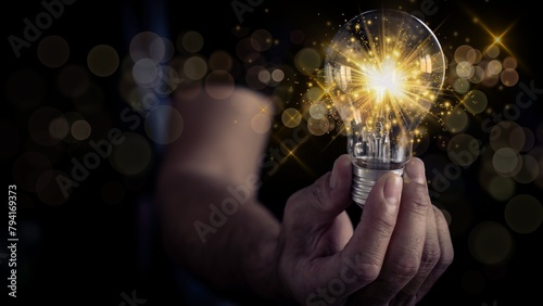 Hand holding a light bulb, innovation, new ideas, creativity, and inspiration. Businessman's hands holding light bulb and brain with digital technology, data network with copy space