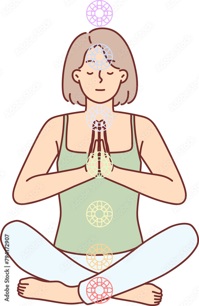 Woman practices yoga sitting in lotus position to cleanse aura and activate chakras to achieve perfection. Young girl folds hands in front of chest while meditating and doing yoga.