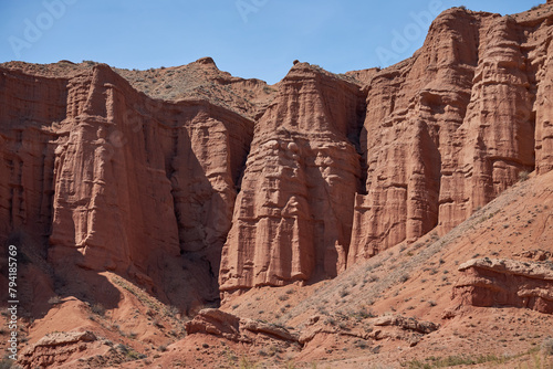 Konorchek canyon, sheer cliffs subject to erosion, travel destination, famous landmark Kyrgyzstan, Central Asia. Rock formation, natural landscape, hiking trekking area, sandstone red rocks photo