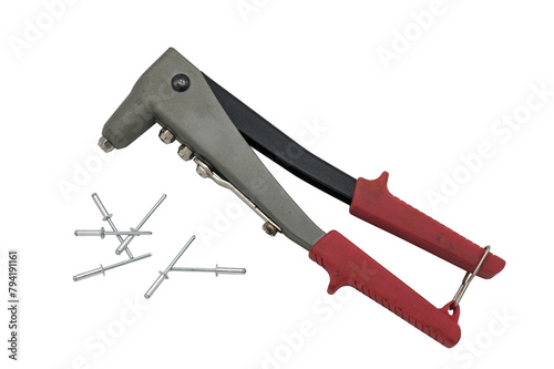 Detail of a manual riveting tool and a few rivets on white background.
