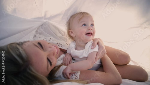Healthy Happy young mum and baby playing in Park