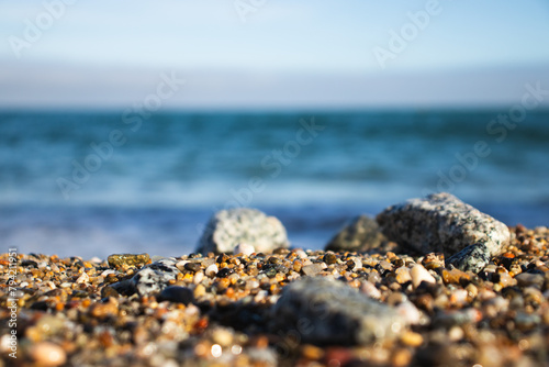 Llevant beach, Barcelona, Spain, on a sunny day, waves and sea, blue sky, sand, pebbles and rocks, summer vibes photo