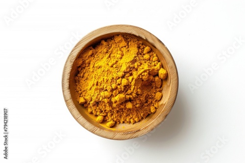 A wooden bowl filled with yellow powder on a white surface. Suitable for food and cooking concepts