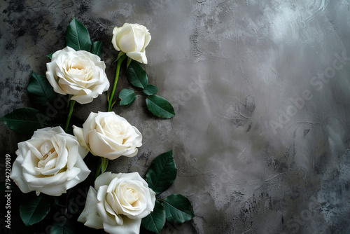 Black funeral ribbon and white roses on dark background