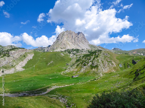 Scenic mtb trail with view of Rocca La Meja near rifugio della Gardetta on the Italy French border in Maira valley in the Cottian Alps, Piedmont, Italy, Europe. Hiking on sunny summer day in mountains photo