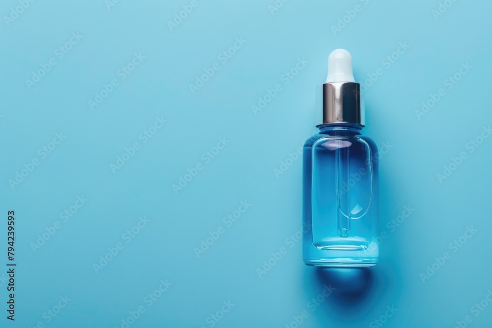 Blue liquid bottle on blue surface. Suitable for science or laboratory concepts