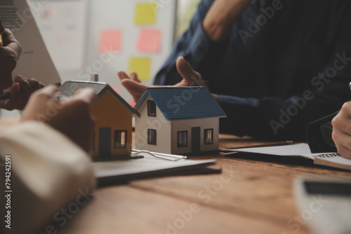 Real estate agent and Sales manager team analysis pricing of rental lease contract of sale purchase agreement, concerning mortgage loan offer for and house insurance.
