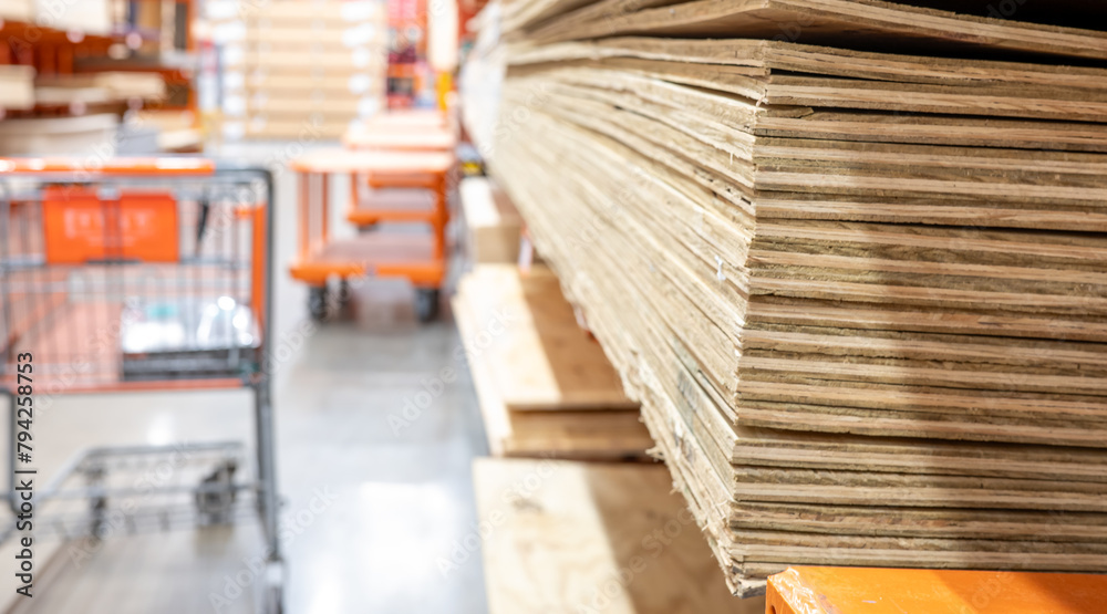 Selective focus on corner edge of stacked plywood at a lumberyard hardware store. Selective focus on corner edge of stacked plywood at a lumberyard hardware store.