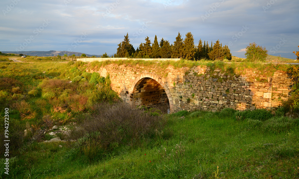 The Persian Mausoleum, located in Foca, Izmir, was built approximately 2500 years ago. There is also an old bridge built during the Ottoman period right next to it.