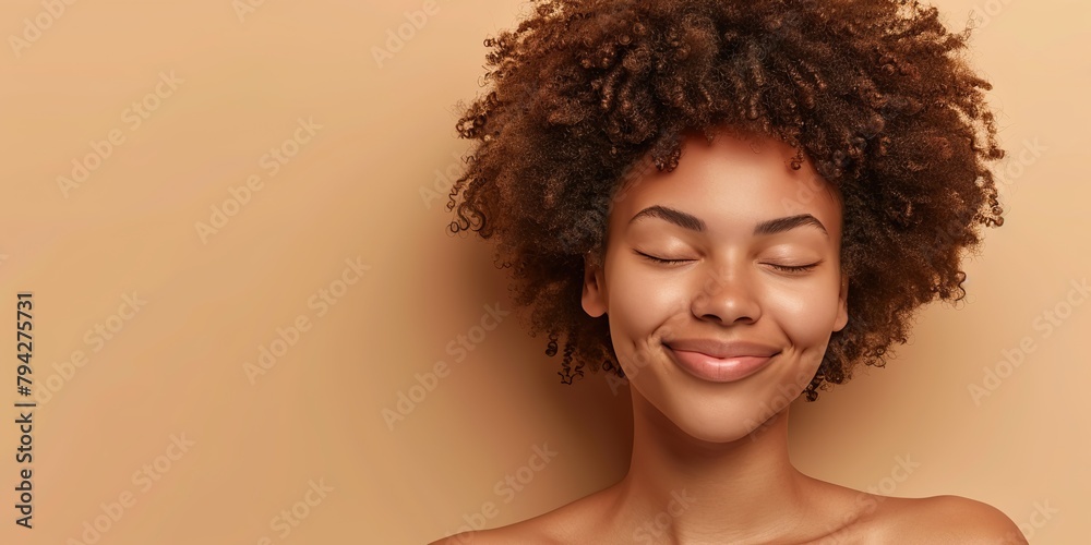 Banner portrait of serene girl with eyes closed and smile isolated on beige studio backdrop. Happy attractive sensual young woman with afro hairstyle, perfect skin, day makeup. Delight, enjoyment.
