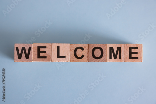 Word WELCOME written on wooden cubes.Wood abc. Holidays and education concept.