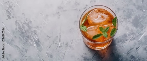 Photo of a julep cocktail with ice and mint leaves, taken from an overhead angle on a grey tablecloth background, in the style of Renato Vieria, Background Image,Desktop Wallpaper Backgrounds photo