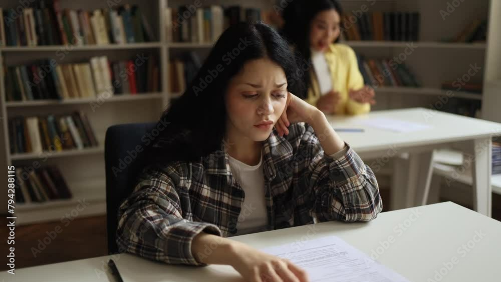 Portrait of upset young asian student got a bad grade on the exam while her group mate happy with high mark at classroom Stressed girl failed exam at university Opposite emotions