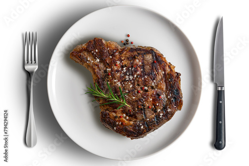 Flavored Whole rib eye beef on white round plate with cutlery