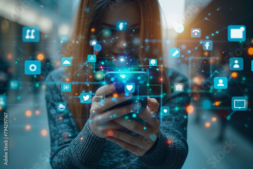 A woman using a smartphone with application and social media icons in virtual or holographic form. Concept of communications, social networks and electronic devices.