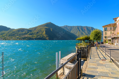 The lakefront walking path on the shores of Lake Como at the small village of Tremezzo, inside the town comune of Tremezzina, Italy. photo